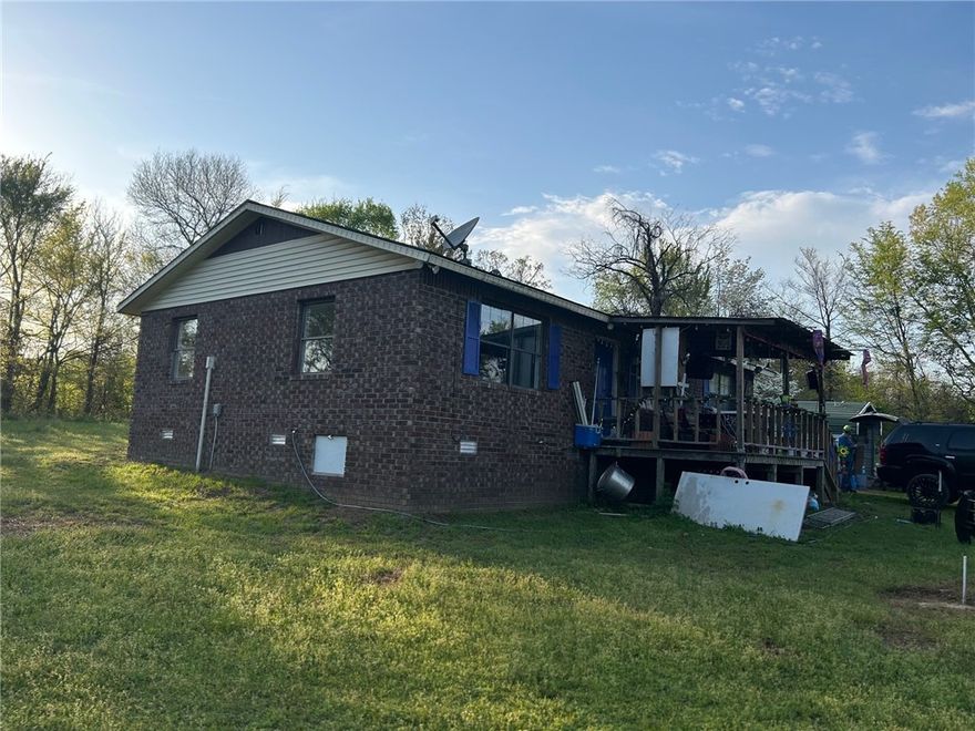 Secluded 3 acres on city water. 3 bed 1.5 bath home, gas not electric. Does have a covered porch as well as a carport that has 3 sides covered.