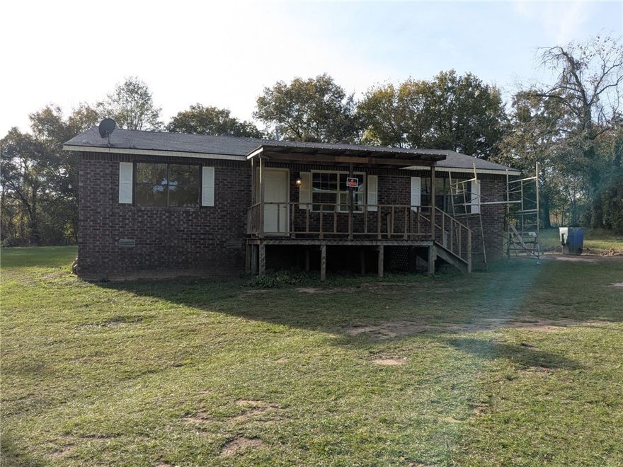 Secluded 3 acres on city water. 3 bed 1.5 bath home, gas not electric. Does have a covered porch as well as a carport that has 3 sides covered.