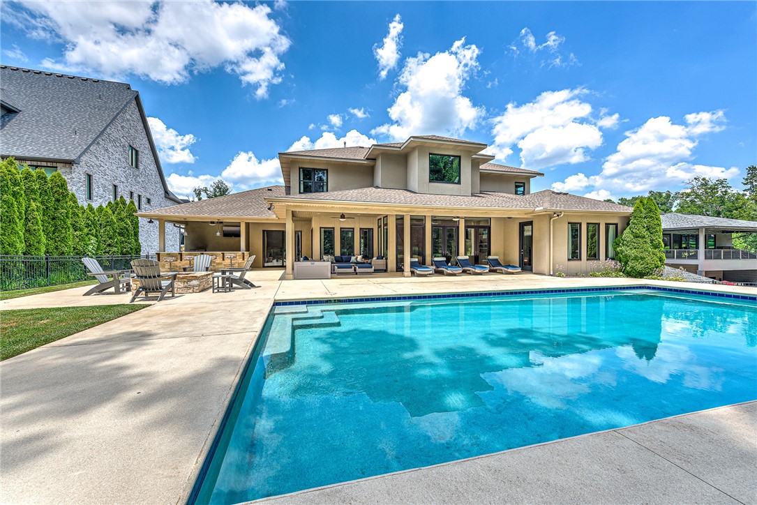 CUSTOM-BUILT SHADOW VALLEY SHOWSTOPPER ON A SPRAWLING .43 ACRE GOLF FRONT LOT BOASTING AN AMAZING BACKYARD OASIS COMPLETE WITH PRIVATE IN GROUND HEATED POOL, OUTDOOR KTICHEN, FIRE PIT AND LOTS OF COVERED PATIO SPACE! This stunning 5 bedroom home offers custom features throughout and enjoys a beautiful, open floorplan that hosts a spacious formal dining just off the foyer, an office/den space w/ fireplace, amazing gourmet eat-in kitchen w/ high-end Thermador appliances, double ovens, large center island, 2 sinks, large walk-in pantry, ice maker, and wine fridge! The kitchen flows beautifully into the spacious living room w/ fireplace, built-ins and a wall of French doors walking out to the backyard paradise! Main level master retreat w/ private patio/pool access, main level guest suite. Second level features 3 gracious bedrooms each w/ an en suite bath, large bonus/game room overlooking the pool/golf course & a private office! Within walking distance to clubhouse, pool, tennis courts & more! Golf Memb conveys.