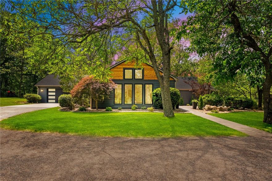 This stunning, fully-remodeled home blends impeccable modern-organic design with thoughtful functionality on 5.24 secluded acres. Every inch has been reimagined, from the updated floor plan, now featuring an added bedroom with en-suite bath and a welcoming new entryway, to the top-to-bottom renovations including new electrical, plumbing, windows, flooring, cabinetry, countertops, and paint. The kitchen is a showstopper, boasting expansive luxe countertops, custom cabinetry, and a hidden butler’s pantry to keep your workspace pristine. Step onto the oversized 450 sq ft stamped concrete patio and start dreaming…there's even a pool rendering off the back deck to spark your imagination. A whole-house generator adds peace of mind, while a new mini-split HVAC keeps the nearly 300 sq ft bonus space behind the garage, ideal for a gym or office, comfortable year-round. This is more than your basic remodel…it’s unforgettable.