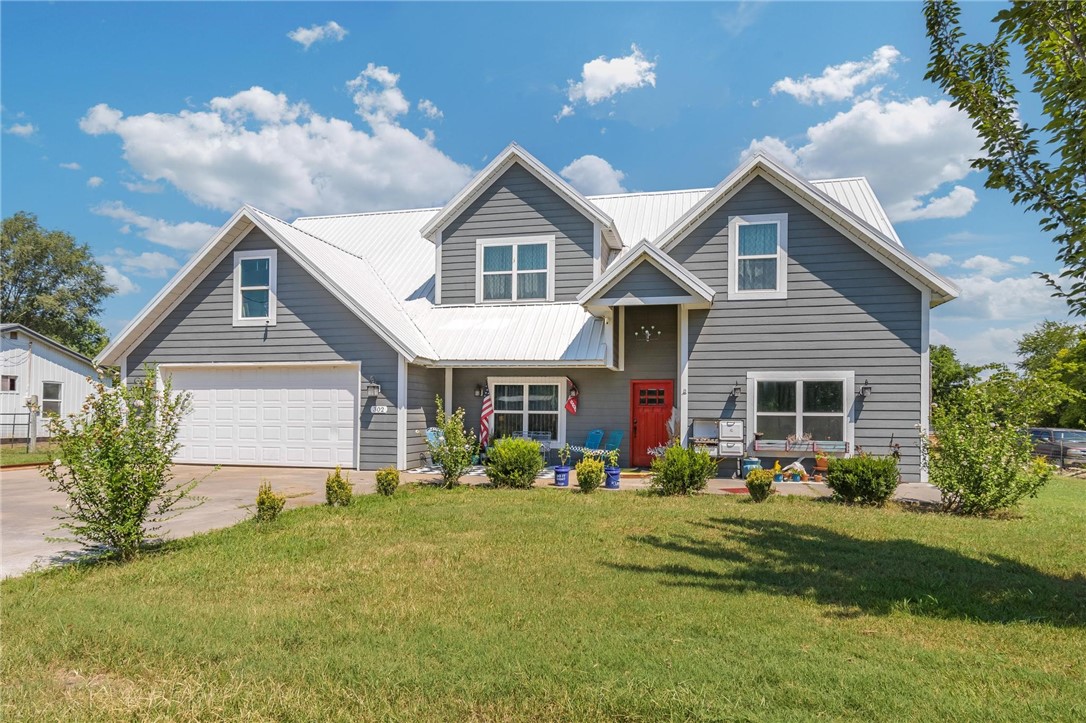 Custom-built home on 1 acre at the end of a quiet street in Gentry. Offering 4BR/3.5BA, 2 living areas, game room, office, and a spacious laundry room. Main level features heated concrete floors and a kitchen built for entertaining with an oversized island, concrete countertops, built-in wine fridge, farmhouse sink, and all appliances (electric oven with gas option). Laundry includes a farmhouse sink & built-ins. Central vac system throughout. Primary suite has walk-in shower, jetted tub, and walk-in closet. Upstairs: 3BR, 2 baths, and 2nd living/game room. Each bedroom includes walk-in attic storage. 2-car garage completes this well-designed home close to everything in town.