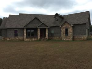 Captivating custom built home at 95% completion on three acres with pond. Concrete counter tops and concrete flooring with cedar walls, stainless steel appliances, office, theater room, bedrooms, and covered back porch. $265,000.