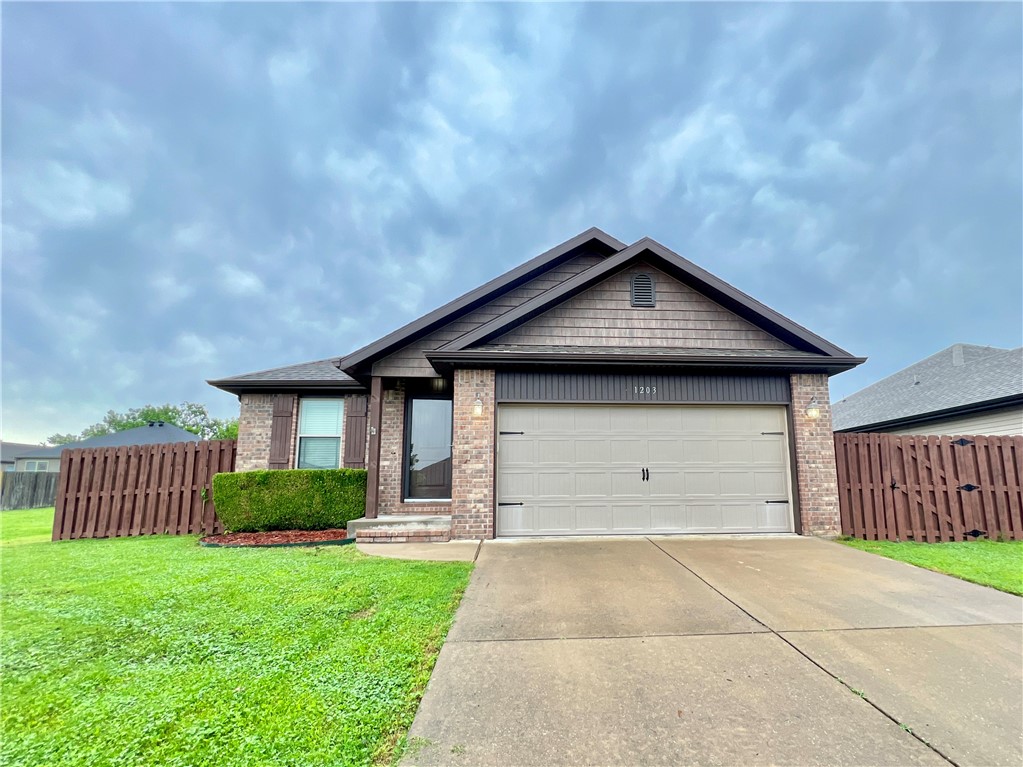Welcome home to this well-maintained home in the heart of Rogers! Easy access to HWY 49 and close to downtown Rogers. Inside the front door, you will see a spacious living room with hardwood floors, tray ceiling and open to kitchen and dining room. An arched entry in the kitchen showcases a dedicated dining area with an L shaped kitchen that contains, granite countertops and an electrical range. Nice sized laundry room located off the kitchen with close proximity to the garage. Primary suite is down the hall, also with tray ceiling details and an ensuite that has walk in closets, dual vanities and extra storage. Two other bedrooms and one bathroom complete the inside of the home. The backyard has easy access from the dining room and is fully fenced with a privacy fence that has been recently stained. Great property that will not last long!