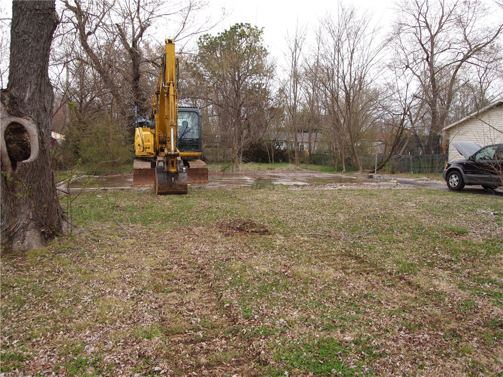 This is a vacant lot in the opportunity zone. Prior house burned several years ago. There is an existing slab from that house. Great lot in wonderful location to build a new home. Buyer to verify utility meters for sewer/water/electric. Buyer to verify all Rogers building codes/setbacks/etc. Seller is working to get a bid for slab removal for buyer reference. Lot appears to be approximately 70ft wide by 130ft deep.