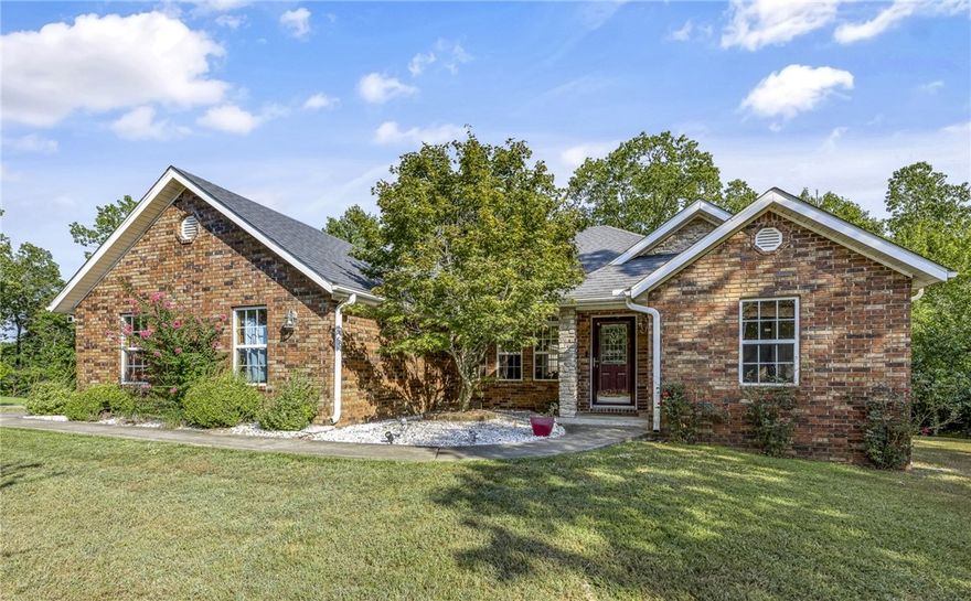 MOTIVATED SELLER! MAKE AN OFFER! TRAILS VERY CLOSE! House on .39 acre corner lot. Large living room; gas-log fireplace; lots of windows for natural light. Formal dining plus kitchen island for bar stools. Lots of cabinets/countertops. Large pantry. Stainless appliances. Instant hot water. 3 bedrooms; split. Huge primary bedroom. Primary has walk-in closet, large tub, walk-in shower. Flooring is wood-look ceramic tile in main living area & primary bedroom, carpet in 2 other bedrooms, ceramic tile in kitchen, dining, bathrooms. Large private deck; partially covered. Roof 2019. A/C compressor & freon 2025. Septic pumped 2024. Attic storage with floor decking. Over-sized garage is heated/cooled for nice workspace (garage space is not included in the listed sq.ft). On quiet street near Lancashire Blvd; convenient to Bentonville, Pea Ridge, Missouri. Very few minutes to many trails (some just 1/2 block). Also near: Lake Ann 2.3 miles; Metfield 3.8 miles with golf complex, swimming, clubhouse, skills park, fitness center.