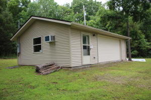 Cabin on the hill with view of the countryside and joins year around Mill Creek. This property has a new well and is a garage with one finished room and bathroom but no septic. Six hundred heated and cooled square feet under roof on 4.78 acres. Bring your RV or add on to the current structure. Only minutes to the Crooked Creek or Buffalo National River.