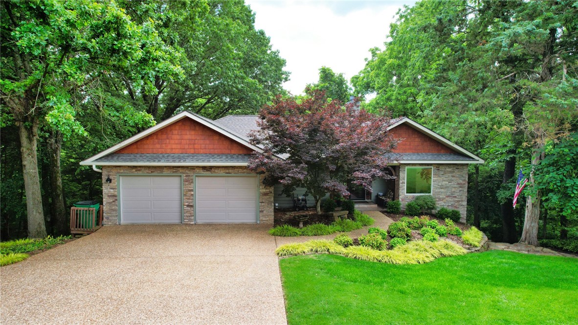 This beautiful well maintained home has a HERS (Home
Energy Rating System) score. The wooded backyard on a little over an acre creates a
charming tree house atmosphere with stunning views year-round. There is an open living
room with a wood-burning fireplace insert, diningroom, & kitchen with a spacious mainlevel deck for entertaining. The home features real hardwood floors, solid wood doors and
baseboards. The main level also includes a master suite, bath, utility room, half bath &
spacious 2-car garage. The lower level has 2 large bedrooms, full bath, private office &
large bonus room with all new carpet insulted. Another second deck has a relaxing hot tub.
Additional features include a boat slip with a lift, a storage cabinet for lake equipment and
easy access to a swim dock via a paved path to multi-slip dock. Also, enjoy a pear & 2
peach trees. Roof recently replaced in May, 2025. This home offers serene country & lake
living while conveniently located just 6 miles from downtown Rogers.