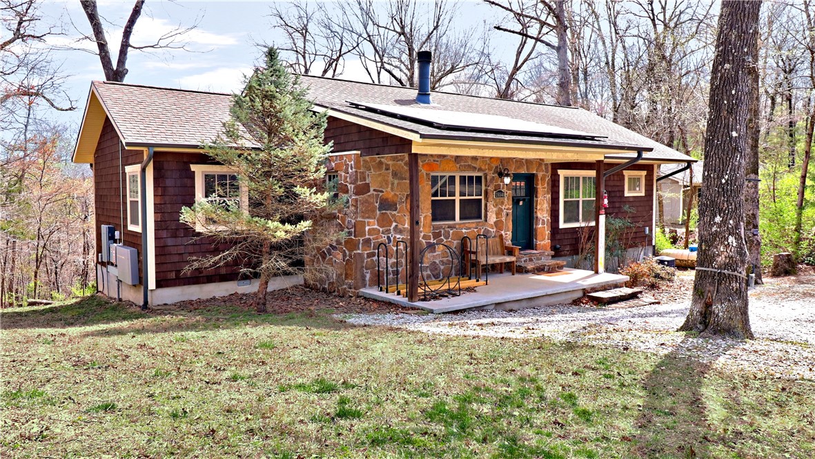 Welcome home to this charming energy efficient cabin on a private wooded half acre lot! Features a sweet covered front porch, large back deck that is partially covered, a gorgeous stone wood burning fireplace, and a detached garage/workshop and carport. New solar panels installed in 2023, and battery bank energy to power select outlets up to 24hrs. Less than a mile to the community boat ramp for White River/Beaver Lake & convenient to Goshen, Fayetteville & Springdale. This is a rare find that you wonāt want to miss!