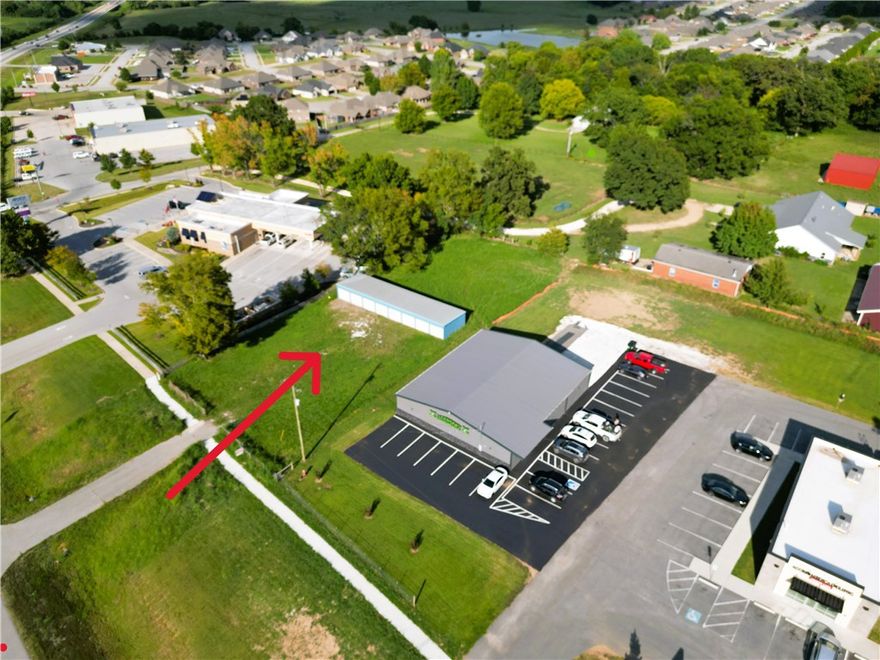 Available lot just inside Prairie Grove along the Hwy 62 corridor, just past the first intersection as you enter Prairie Grove. This .59-acre lot (103' x 261') offers ample space to accommodate a wide range of commercial uses. With over 100 feet of Hwy 62 frontage, the property is positioned between Arvest & Legendary Fitness, benefiting from excellent visibility and average daily traffic counts of ±18,000 vehicles. The property also includes 8 metal storage units, each unit is 10' x 20', providing immediate income potential. Current owners have developed a complete food park business plan, avail for purchase separately. Additional details & info are avail upon request. This is a rare opportunity in a rapidly growing area. Use the existing storage units, build to suit, or purchase alongside the food park plans & get started right away. Surrounded by multiple successful businesses, supported by strong traffic counts, avail utilities, and significant growth, this property is perfectly positioned for future success.