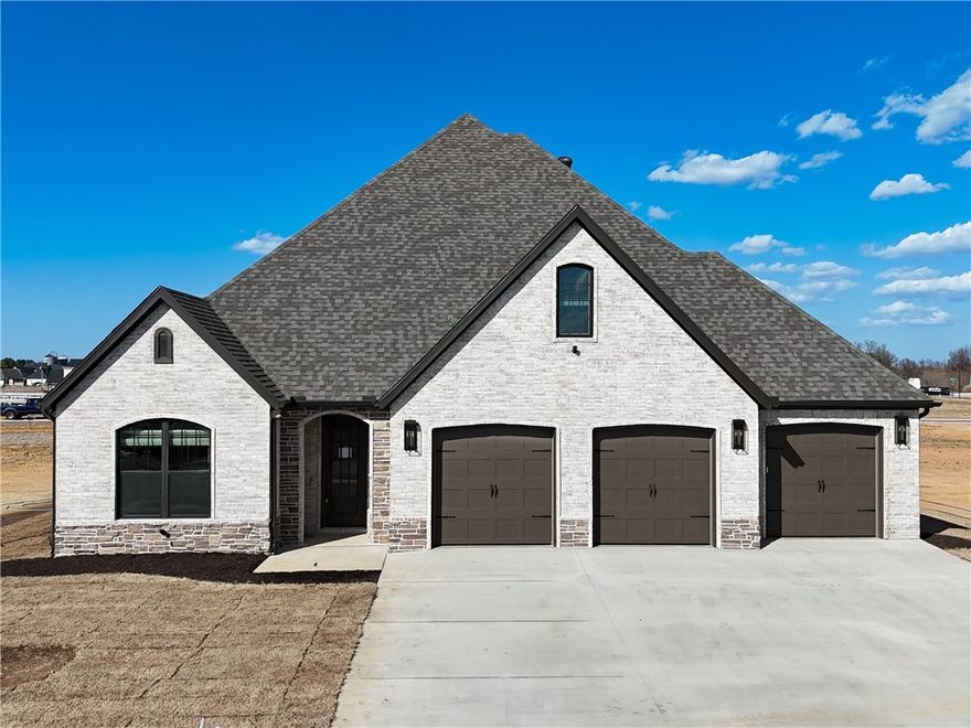 Welcome to County Line Square, a new Springdale community steps from Shaw Family Park with a pool and pavilion for residents. The Ashland entry opens to a guest bedroom or office and a full bathroom on the left, giving you flexible space for visitors or work. The hallway leads into an open living and dining area with a stone fireplace as the focal point and engineered wood floors throughout the first floor. The kitchen connects to the living space and includes a large island, granite countertops, cabinets to the ceiling, GE Profile stainless steel appliances, and a pantry. The main level primary suite features a vaulted ceiling and a bathroom with a double vanity and centered makeup vanity, a walk-in shower, and a large walk-in closet that connects to the laundry room. Upstairs offers 2 bedrooms and a full bathroom. Enjoy the covered back patio and a spacious 3-car garage. A fence, gutters, and blinds are included. Builder’s preferred lender is offering $3500 toward closing costs or a rate buy down. *Agent Owned*