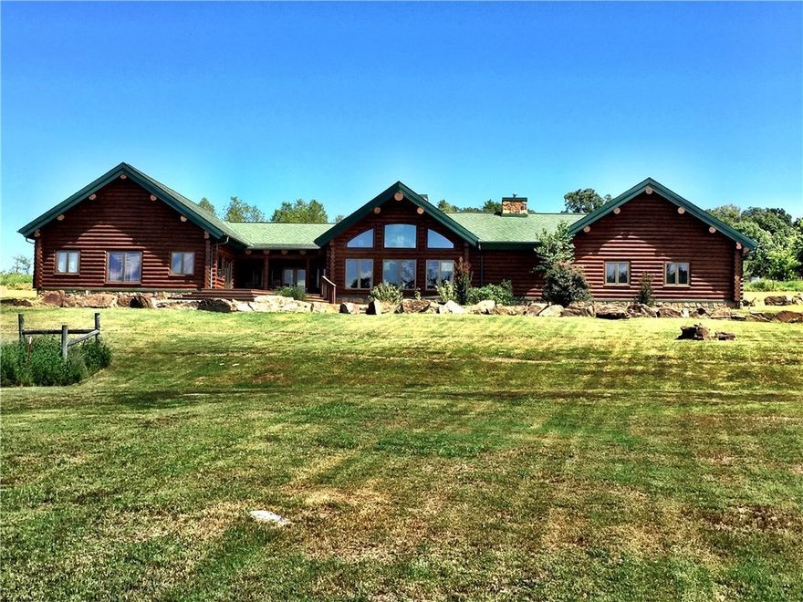 Impressive custom hand crafted log home, freshly updated exterior w/vista views from living/master just 45 minutes from Fayetteville/Ft.Smith. 30 minutes to I-40. Fenced & cross fenced. Beautiful wood floors, soaring ceilings.SS app, granite counters, comm cook top, home gen w/auto switch,Pex plumb. Could be getaway/hunting lodge. 3 spring fed ponds, house on spring water w/filter. Plentiful deers/wild turkey. Oversized garage doors for large pickups,70% pasture, 30% wooded. New Bridge