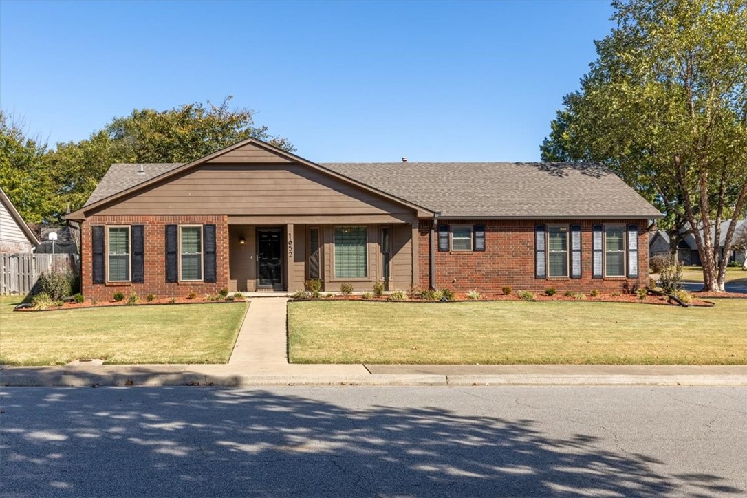 Come live in the heart of Fayetteville in this recently remodeled 1 level charming home nestled on an ample landscaped corner lot with a side entry 2 car garage. Conveniently located with close proximity to Butterfield Elementary & the Razorback Greenway trails, 71B, I-49, shopping, dining, & more! Rest in comfort with recent updates including a newer roof & HVAC. Highlights include a beadboarded foyer that leads you into the lovely living room with vaulted beam accented ceilings & remote control fire place creating a calm ambiance. Modern luxury vinyl floors seamlessly extend throughout as well as double sash windows for abundant ventilation. The kitchen boasts 2" granite countertops & stainless steel appliances. Remodeled bathrooms feature, new toilets, Onyx countertops with under mount sinks & more. The split plan layout offers privacy & practicality with the primary suite featuring a walk-in shower & walk-in closet. Unwind on the covered front porch or covered back patio. Schedule your viewing today.