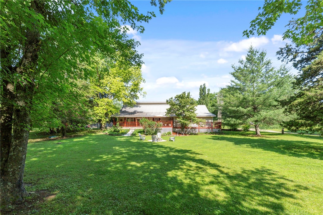 Lake living with acreage! This property sits on almost 2 beautiful acres right across the street from Beaver Lake. Pack up your gear and walk down the street this summer to go fishing. Conveniently located 5 minutes from Downtown Rogers! Also a short drive to Lake Atalanta. The acreage with this property provides you with so many options. Bonfires, build a pool, chickens, you name it. Sit on your front porch and enjoy the serenity and privacy this property provides. Step inside and you'll find an open floor plan. The living room is complete with a wood stove, cozy up this winter inside while you wait for lake season to return. Check out under the stairs, plenty of space to store anything you need. The pantry provides ample storage as well and cabinet space. The oversized garage is great for all your lake and fishing gear. Upstairs you'll find two over sized bedrooms and a bonus room! Come see the slice of heaven on Beaver Lake! This property is outside of city limits.