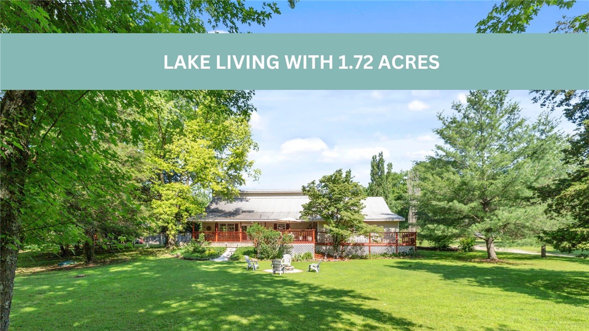 Lake living with acreage! This property sits on almost 2 beautiful acres right across the street from Beaver Lake. Pack up your gear and walk down the street this summer to go fishing. Conveniently located 5 minutes from Downtown Rogers! Also a short drive to Lake Atalanta. The acreage with this property provides you with so many options. Bonfires, build a pool, chickens, you name it. Sit on your front porch and enjoy the serenity and privacy this property provides. Step inside and you'll find an open floor plan. The living room is complete with a wood stove, cozy up this winter inside while you wait for lake season to return. Check out under the stairs, plenty of space to store anything you need. The pantry provides ample storage as well and cabinet space. The oversized garage is great for all your lake and fishing gear. Upstairs you'll find two over sized bedrooms and a bonus room! Come see the slice of heaven on Beaver Lake! This property is outside of city limits.