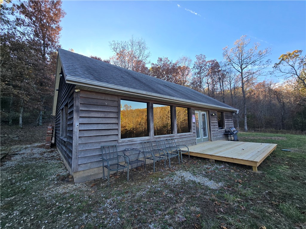Nestled on 100 acres in the Ozark Mountains, this 1440-square-foot home, built in 2011, is ideal for a hunting getaway or a residential space. It features one BR, two BA, and a bonus room upstairs. Rubber laminate and tile flooring, fresh paint, new cabinetry, new fixtures, pantry, secret room, decks, etc.. Large windows throughout. The cast iron wood-burning stove keeps it toasty on cold nights. Deer, bear, turkey, etc. 8'x8' blind with a 50 gal suspended feeder. Tons of native stone, bluffs, caverns, large mountain streams, hardwood, Oak, Hickory, Persimmon, Wild Cherry, one Sycamore measures over 4' across. Some trails across the property. We counted 26 springs on 40 of these acres alone. Home currently utilizes a propane generator. We recently acquired an electric easement; we are cutting that easement now. Rainwater collection & spring water currently used. No access to rural water, need a well, has septic. Will divide acreage, more listings splitting it up coming soon. Detached 1 car garage/shop. Agent owned