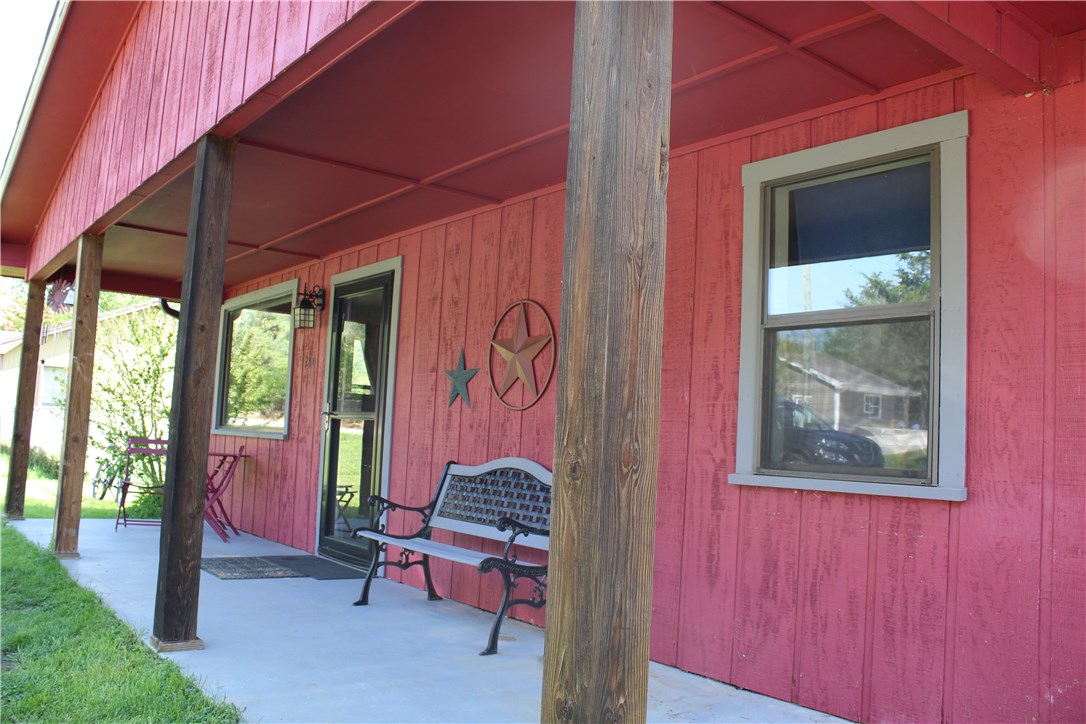 Look at this front porch! A big flat lot on the edge of town. Perfect starter home or the growing family with 3 bedrooms and a bonus/4th bedroom, 2 bathrooms and great kitchen. New roof in 2017