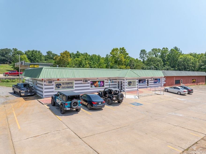 12,000 square foot Income Producing property, strategically located on prime highway frontage just off the I-40 exit in Alma. Fully operational smoke shop w/drive thru window, new interior renovations with updated plumbing and electric, with private and commercial restrooms. Located on a 1.4-acre lot with room to expand. Business and Inventory included. Three separate spaces: retail, office suites & warehouse. Cash-flowing flexible-use asset. Ideal for investors or owner operator with immediate cash flow. Sellers have almost finished the remodeling and have one office leased at $1500 per month on a one-year lease. Two more will be ready soon.