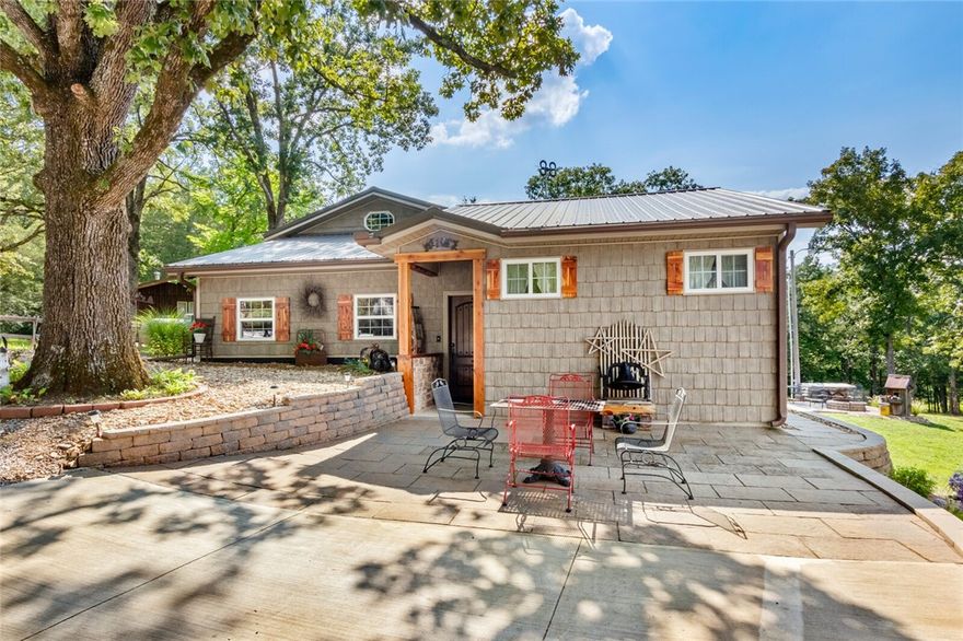 Enjoy Lake Life on Beaver Lake with your one of a kind custom lake home with private boat dock just 200 steps away! Craftsmen Style Home on nearly 1 acre with a gentle stroll to the lake. The yard is perfect for summer games and cook outs. Relax on your deck, down by the fire pit,  or in the new 8 x 12 swim spa. The home features 3 bedrooms and 2 baths downstairs, the loft area has a full bath as well. The eat in kitchen has a cozy gas log burning stove. The property also has a 36X40 building with 13x39 part partitioned off with heat and air. Could be made into bunk house for extra guests. Overhead Garage door is 8'8"x 18' . Also has an attached 10x24 lean-to. The private boat dock has a swim platform and a 6,000 lb lift. Everything you could ever want in a lake home!