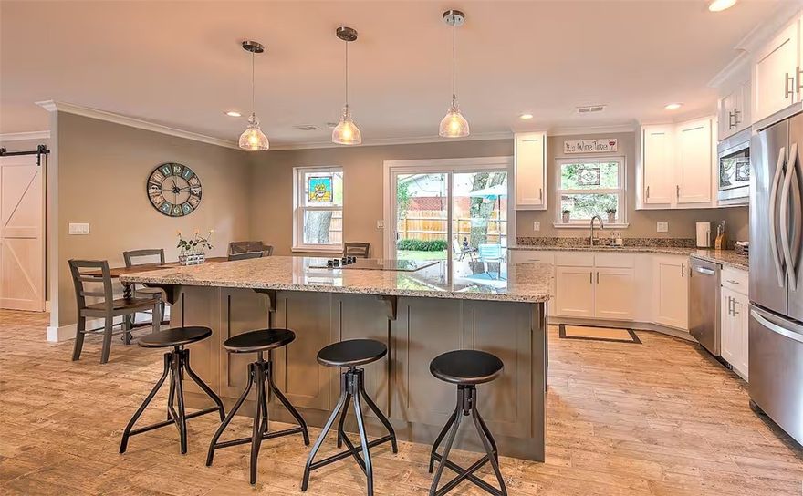 Just a short walk to the Bentonville Square, this one-level stunner combines thoughtful design with laid-back charm. The open layout is warm and welcoming, from the stone fireplace in the family room to the oversized island in the stylish, well-appointed kitchen. Sliding barn doors add flair while revealing a walk-in pantry and a full laundry room. Three spacious bedrooms with custom closets. Both bathrooms are beautifully remodeled with a spa-like design. But the real surprise? The backyard. Shaded, private, low-maintenance—with lush lawn, winding paths, mature trees, and a patio built for star-filled evenings and sunny brunches. There's a secure shed for bikes and gear. Refrigerator, W/D all stay. Furnishings are negotiable. This home is a Top 1% Airbnb Rental in the US. Whether purchased as a new family home or optimizing on a proven investment property, this is a rare blend of comfort, location, and single-level living in the heart of Bentonville.