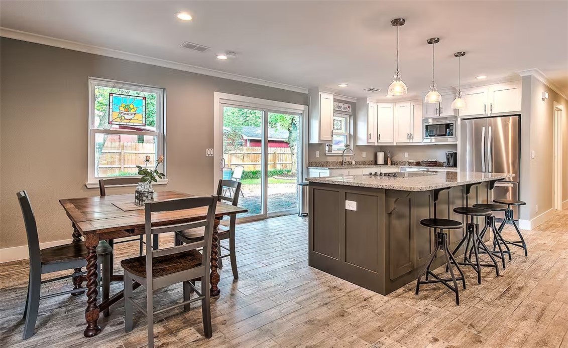 PRICE IMPROVEMENT: $799,000. Just blocks from the Bentonville Square, this 2017 fully renovated home blends elevated design with comfort and style. Quality finishes, natural light, and open-concept layout flows effortlessly from the cozy living room with stone fireplace to the entertainer’s kitchen featuring a huge island, granite countertops, electric cooktop, and stainless steel appliances. All 3 bedrooms feature custom-designed closets. Both bathrooms are beautifully updated—check out the spa-style shower in the primary suite. Barn doors access the laundry room & walk-in pantry. Outside are mature shade trees, low-maintenance landscaping, patio perfect for entertaining, or just relaxing under the stars. Secure storage shed in backyard for bicycles and equipment.
Furnishings are Negotiable: furniture, décor, appliances, and supplies, create a move in ready opportunity. This home has been on the Airbnb Top 1% rental list in the US. See Attachments.
