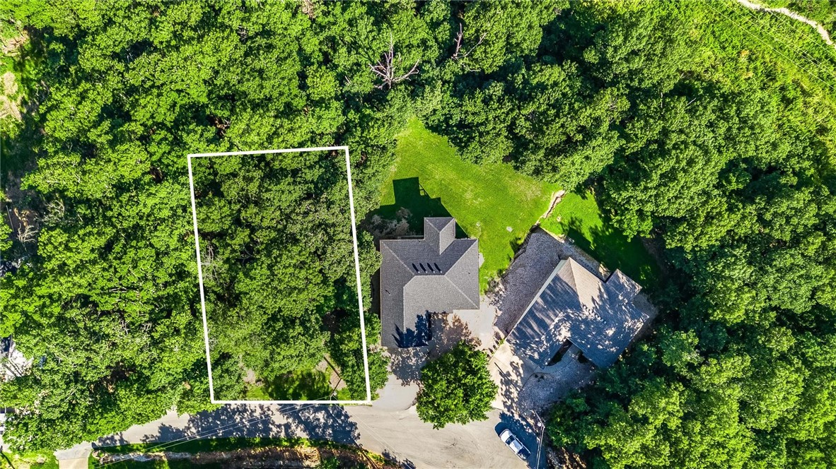 An exceptional building lot nestled in the natural beauty of Bella Vista. Tucked away on a peaceful, wooded cul-de-sac, this lot offers the perfect canvas for your future home. Nature lovers and outdoor enthusiasts will appreciate the unbeatable location. Just steps away from the renowned Back 40 Bike Trail, this lot is ideal for biking, hiking, or simply enjoying the lush surroundings. Spend your weekends kayaking or paddle boarding just minutes away at Lake Ann, or hit the fairways at Bella Vista Country Club, also nearby. Whether you're planning your forever home or a getaway retreat, this lot delivers the peace of nature with the convenience of proximity to recreation, amenities, and major routes. Don't miss this rare opportunity to build in one of Bella Vista’s most desirable locations.