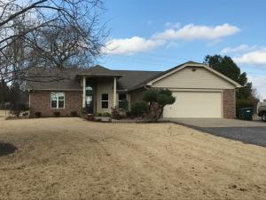 IMMACULATE AND UPDATED! Don't miss this great 3 BR, 2 BA home on 2 acres in Golden Pond subdivision. Open concept floor plan features wood and tile flooring throughout. Updated, modern kitchen has quartz countertops, lower pull-out cabinets, and extra deep single bowl kitchen sink. Bathrooms are updated with subway tile surround around new cast iron tub in hall bath and walk-in tile shower in master bath. And don't miss the bonus sunroom! Fabulous backyard has built-in seating on patio, basketball goal, 2 storage sheds and a beautiful gazebo. Roof, HVAC are 10 years old, water heater with recirculating pump is 3 years old. If you're looking for a quiet, peaceful setting, but still close to town, this is it!