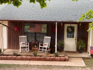 You wont want to miss this charming 2 Bedroom 2 Bath home before it slips away. This beauty is nestled in the woods with the convenience of being right off the highway within 5 minutes to access to kings river. The attached garage with gas heater can be used as a home gym or easily turned into a third bedroom. Great for Entertaining with a semi open floor plan, and enjoy your morning coffee or an evening beverage while watching the wildlife on the screened in back porch. New water softener installed in 2021. All appliance will convey except washer and dryer. Home is on a shared well with a well agreement.Along with a 30 x 50 shop that you can make your man cave or she shed, there are also other outbuildings that can be utilized.Jasper school district, confirmed berryville bus route