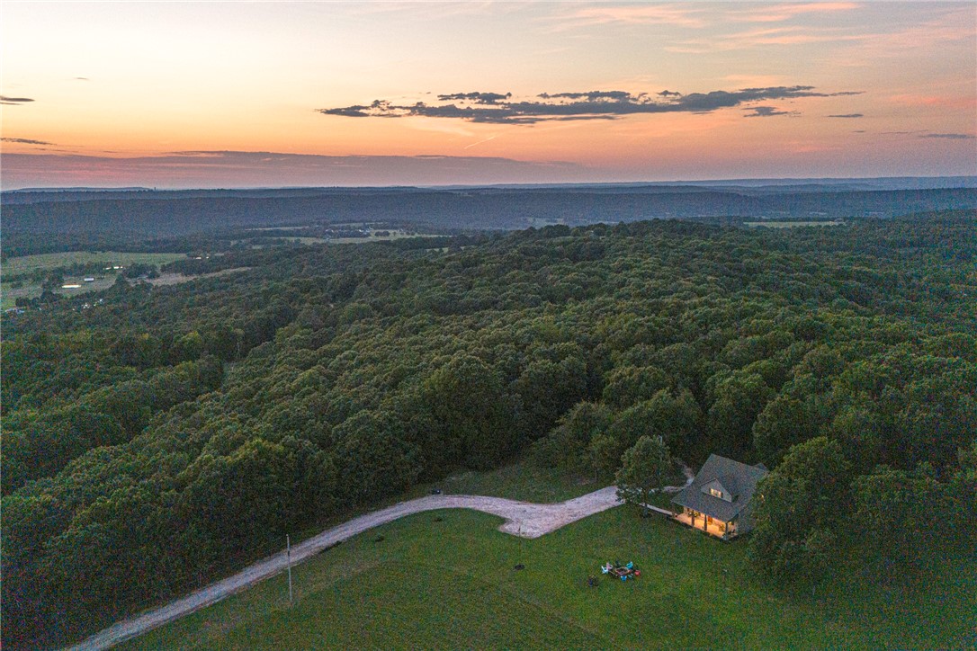 HOME SWEET HOME! This gorgeous 4 bedrm 3 bathrm home on 12.86 acres+/- is nestled the rolling hills of Northwest Arkansas near Devils Den State Park. Location boasts privacy while being 10 mi from West Fork & I-49, & <30 min from Fayetteville & Prairie Grove! Enjoy sunset & mountain views from the comfort of the covered front porch spanning the length of the home! Head inside to an open concept L-shaped kitchen feat: concrete counters, lots of storage, stainless steel apps, separate range/oven, island with room for more seating, & walk-in pantry! A formal dining space perfect for hosting friends & family! Hang out in the living room w LVP flooring & gas log fireplace! Rejuvenate in the main floor primary bedrm with private suite! Main floor also incl additional bedrm, full bathrm. Mudrm w built-ins, & laundry rm with folding counter & storage! Upstairs a large bonus room perfect for 2nd living rm or media rm! Two more bedrms & a full bath! Covered back patio & storage shed! Donāt miss out! Schedule a showing today!