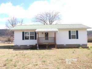 Nice home with a newer metal roof, vinyl siding, front covered porch, a rear deck, a water well, shed and6 ac m/l of develop able land in town. Nice location with nice larger brick homes near by and a view of the mountains from the rear deck. All for $79,900