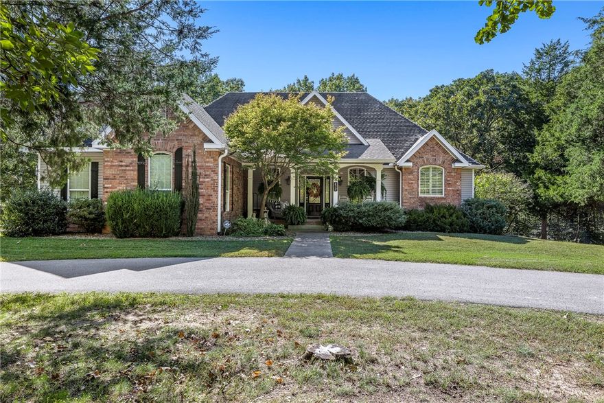 Prime location 3 minutes to Downtown Rogers/Lake Atlanta 5 Minutes to Prarie Creek boat dock. From the time you step into the foyer to a cozy living space for all your gatherings to the vaulted ceilings/stone fireplace this home has it all.  A modern kitchen with a large island w/prep sink, 5 burner gas stove & pot filler, breakfast bar, walk-in Panty & covered deck for all your grilling.  Master BR main level with large Master bath , walk-in shower, double shower heads, his & hers walk-in closets and a door way to your covered deck for your coffee in the a.m. & your glass of wine in the p.m. 2nd Master suite w/bath downstairs could be mother-in-law quarters.  Large family room w/ wood burning stove w/built-in office desk & computer hook ups & wine/soda fridge. Two more guest Bedrooms with full bath & covered patio downstairs.  Just steps away is your 1900 sq ft. heat/air, kitchen /bath shop for your RV or use for a pickle  ball court.  This all sits on 7 + Acres.  Call for a private tour of a very unique place.