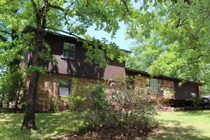 Walk to Lake Dardanelle State Park from this fantastic 4 bedroom, 3 bath home! Split level features a living room on the main level and a HUGE family room with wood burning fireplace on lower level. New roof (April 2020) Exterior Paint (May 2020) and new gutters too. Modern, up-to-date kitchen and awesome 1.16 acre outdoor space makes this gem a steal! Outbuilding is heated and cooled, large entertaining decks and wet weather creek too. SF is taken from tax record and taxes are before homestead credit.