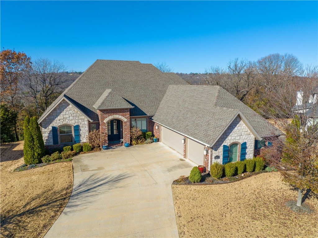Discover the perfect family home! This 4-bedroom residence includes a bonus room, office, and 3.5 baths in a sought-after neighborhood. The remodeled wood grain porcelain tile in living areas creates a cozy ambiance. Enjoy an open kitchen with vaulted ceilings, gas fireplace, and a large island. Features include double ovens, granite counters, wine fridge, and a gas cooktop. The primary bedroom offers upgraded LVP flooring, dual vanities, soaking tub, tiled shower, and a walk-in closet. Relax on the 14 x 11 screened porch or 13 x 20 covered deck with gas fireplace enjoying the scenic view in a private setting. This home combines luxury and practicality in an ideal setting. Don't miss out—schedule a showing today!