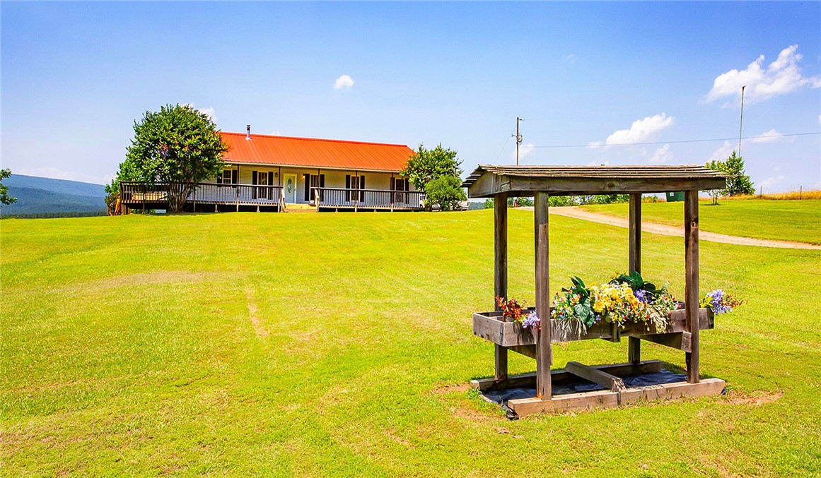 Escape to the simple country life on this 24.2± acre property, where modern conveniences meet rustic charm. The 4-bedroom, 2-bath, 2176 sq. ft. home offers an open layout with cathedral ceilings, a cozy wood-burning stove, and hand-crafted pine walls that add warmth and character. Beautiful hardwood floors stretch across the main living areas, inviting you to kick back and relax. Step outside to take in the sweeping views of the Ozark Mountains and a peaceful pond thatās perfect for unwinding after a long day. The property also includes a 2000 sq. ft. insulated red iron shop with electric and an artesian well perfect for projects, hobbies, or extra storage. A metal carport with water and power is ready to shelter your camper or boat. Enjoy county water, fiber internet, and plenty of room to roam, this property truly offers the best of both worlds. This one-of-a-kind property is a must-see. Schedule your showing today!