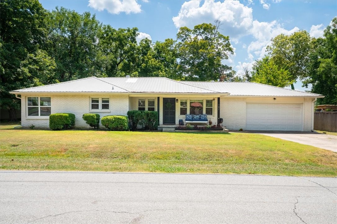 Remodeled home in the middle of downtown Prairie Grove. Walk to downtown antique stores, coffee shops, restaurants and nearby attractions. Spacious level lot with mature trees that shade the fenced backyard. Stainless steel kitchen appliances and large kitchen island with granite countertops. Patio area is perfect for enjoying the fall breeze. You will love the open floor plan and natural sunlight. New stainless steel refrigerator included! Two car garage with large driveway, metal roof and covered front porch. Half a mile walk to tennis courts and 1,000+ acre Prairie Grove Battlefield State Park. Charming!