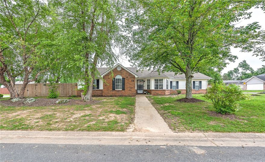 Charming corner-lot home in a prime location, just a short walk to Centerton Lake, parks, and local restaurants! This well-maintained 3-bedroom, 2-bath home features vaulted ceilings and abundant natural light throughout. Enjoy spacious rooms, a fenced yard with mature shade trees, and a large covered patio—perfect for outdoor entertaining. Recent updates include a new roof in 2017, luxury vinyl plank flooring throughout, a new patio roof, and new kitchen appliances in 2022. The kitchen has been beautifully upgraded with new granite countertops, a stylish tile backsplash, and a large farmhouse-style sink. Solar panels provide energy efficiency and help reduce utility costs, making this home both eco-friendly and budget-conscious. Don’t miss this beautiful, move-in-ready gem in a convenient and desirable neighborhood!