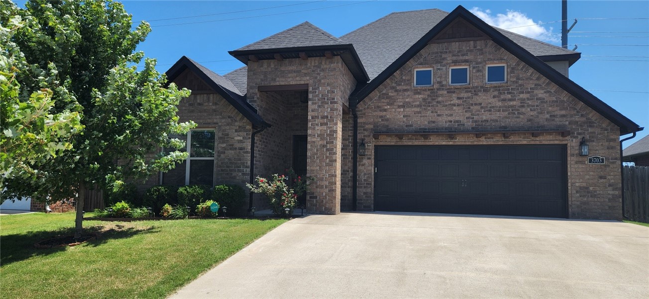 Beautiful 4-bedroom home in Rolling Acres Subdivision. The foyer opens to the living room directly ahead and is adjacent to a short hallway accessing a full bath and guest room. The spacious living room has a cathedral ceiling with wood beams, large gas fireplace, and a wall of windows. It is open to a large kitchen with an oversized island. The countertops are granite and paired with white cabinets enhancing the bright and inviting atmosphere. The dining area is adjacent to the kitchen. Beyond it is the primary bedroom, which has access to the primary bath with walk-in shower, large soaking tub, double sinks, private lavatory and walk-in closet. The laundry room can be accessed from the primary bedroom or hallway. The remaining two bedrooms and full bath are upstairs. Corne see this beautiful home before it's too late.