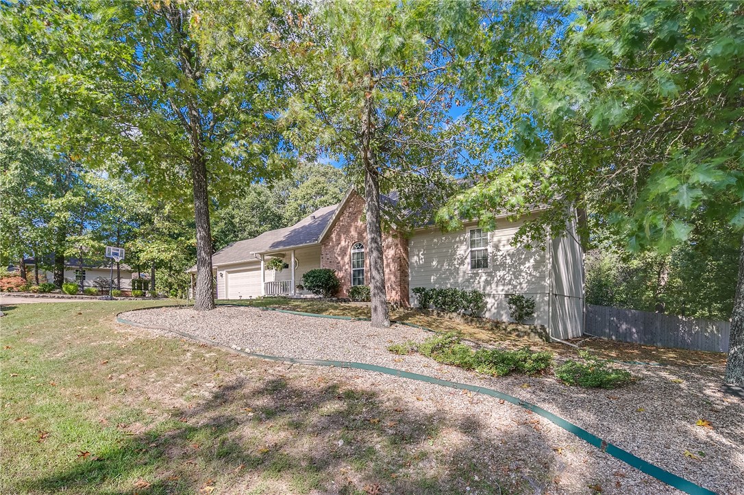 Immaculate home excellent, location setting on two lots w/ privacy fenced backyard. Glass gives it class! Open the front door & enjoy a view of woods thru sunroom windows. Newly updated in 2012 to include Trane HP, laminate flooring, roof, lighting and more. Enjoy private surrounding from sunroom, deck or patio, 2 car garage & carport. 2 bedroom septic design. Get Ready To Move!