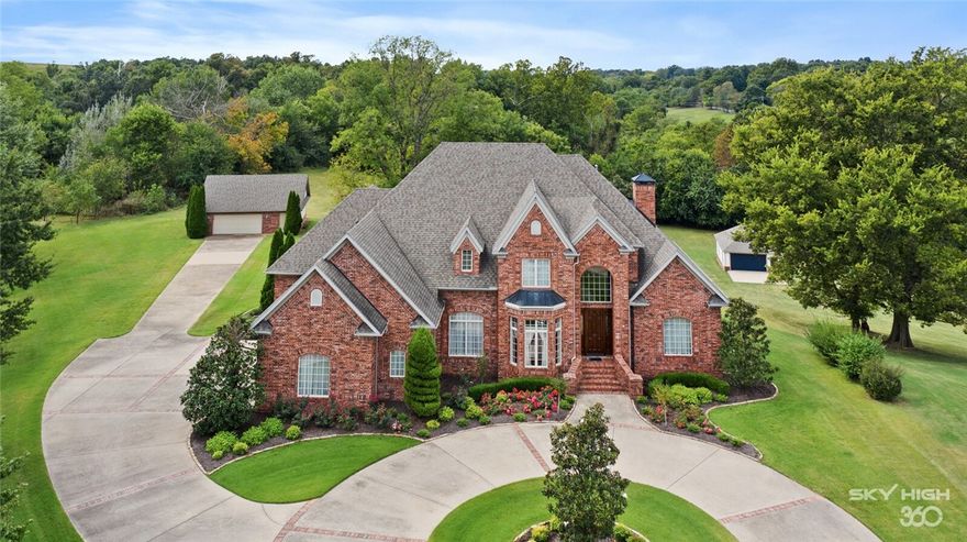 Tucked away in the exclusive Sycamore Hill subdivision, this fabulous custom home sits on a 2.22 acre estate lot canopied by mature trees & gorgeous gardens. This 5 bedroom, 3 full, 2 half bathroom impeccably designed home features an impressive, curved staircase, wood flooring, built-ins, beam & tray ceilings and secondary staircase. This spacious layout offers 2 living areas on the main level, formal dining room, study w/built-ins & open designer eat-in kitchen. Sumptuous Primary Suite features a sitting area, private patio access, and a incredible large spa-like bath with designer walk-in closet. Upstairs features 4 secondary bedrooms, a bonus/bedroom and a fully equipped home theater. Enjoy serene property views with classically styled swimming pool with spill over spa, gardens, and a sweeping southern lawn. This home offers the best of both worlds with its perfectly convenient location to I-49, JB Hunt Headquarters and direct access to the Razorback Greenway Trail with the ultimate privacy “out of town” feel.