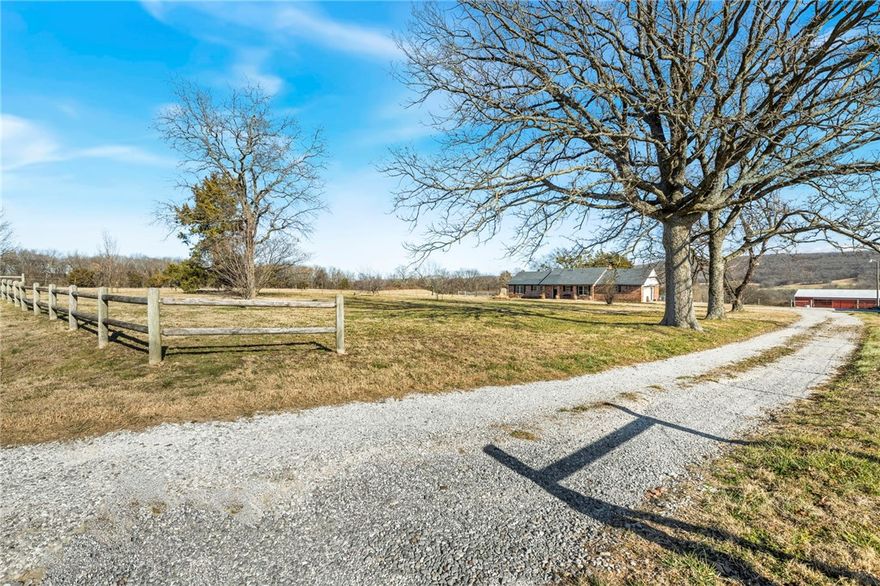 10 Acre homestead just minutes from Prairie Grove offering the perfect blend of modern comfort & country living. This 4BR/3BA-1,968 SF home was taken down to the studs in 2018 & completely rebuilt w/new electrical, plumbing, windows & insulation, plus a new roof added in 2022. Inside, you'll fall in love w/the burnt tongue & groove cathedral ceiling w/exposed beams, & wood-look ceramic tile flooring throughout. The kitchen has a gas cooktop, granite countertops, & a hammered copper farmhouse sink. Outside, the 40x60 barn features built-in pipe bale feeder, stalls, & two sliding equipment doors. The 30x50 shop has a concrete floor, 220 wiring, sliding equipment doors, & a walk-through door. The land has breathtaking mountain views, well-established grass, & holding pens w/head chutes. The property is completely fenced & cross-fenced. The large pond w/established fish is perfect for relaxing evenings or family fun. This is a rare opportunity to own a turnkey homestead in an incredible location. Don't miss it!