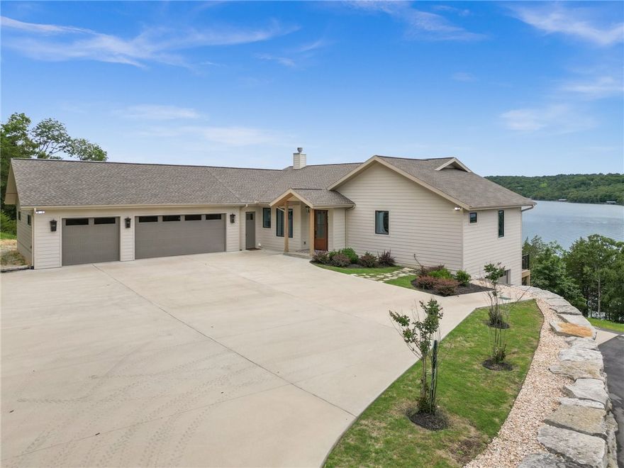 Welcome to a Masterpiece of Luxury Lake Living in the heart of Beaver Lake. Breathtaking views! This 4 bedroom, 4 bath estate offers 649' of lake front, cove protection, with spectacular main channel views,  a private 2 slip boat dock, 2 lifts, 2 PWC platforms. The main living area features a grand fireplace, expansive living and dining spaces, and an oversized chef's kitchen with top-tier stainless appliances, custom cabinetry, quartz countertops, standout backsplash, large island--perfect for gourmet cooking. The Primary bedroom provides a private sanctuary with a spa-like ensuite, walk-in closet and serene lake views. The main level guest bedroom features a large picture window for lake views and a full bath. Downstairs includes a living area, game room, 2 bedrooms, 2 full baths,  office/bedroom with direct lake access. Laundry facilities on both levels, too. This home blends modern luxury with lakefront style. Don't miss this rare opportunity to own one of the lake's most impressive properties--a true paradise.