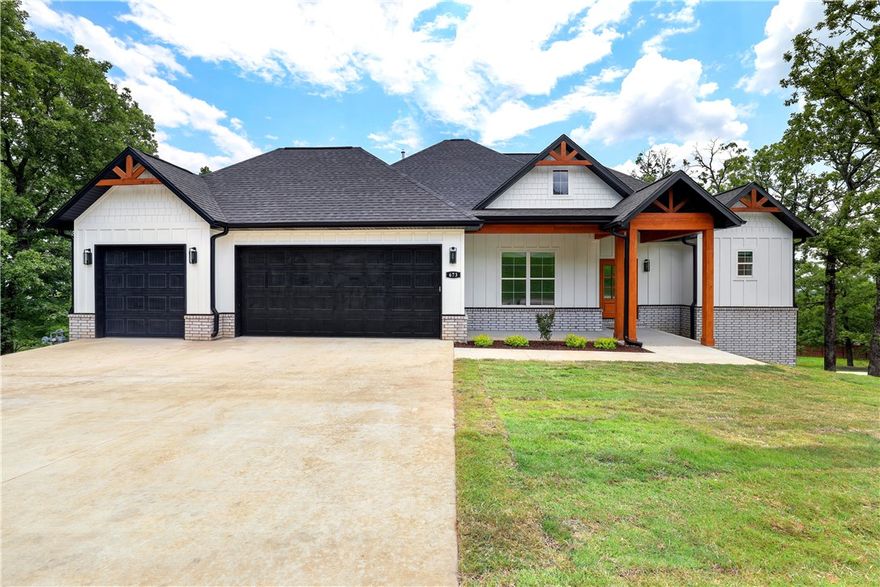 What a view from this sweeping deck! Gorgeous new construction has views of the sunrise and sunsets! This 2 story home is full of upgrades & amenities! The kitchen is an entertainer's dream with its large island covered with gorgeous "leathered" granite, the custom backsplash with under cabinet lights, & its 6 burner Fisher Paykel gas range and wall oven. Solid wood look tile flooring covers the main living spaces & leads you into the primary bedroom with tall tray ceilings. The primary ensuite has matching granite, a soaker tub, a large walk-in tiled shower, & a huge walk-in closet with natural light! The split plan has a large laundry/mud room, guest bath, & guest bedroom ensuite. As you go downstairs you will find a huge bonus or second living room flanked by 2 bedrooms with a shared bath. The huge 23' x 17' bonus can be used for a media room, playroom, exercise room, or more.  If you are looking for a gorgeous craftsman style home in coveted East Fayetteville this one is a must see! More photos coming soon.