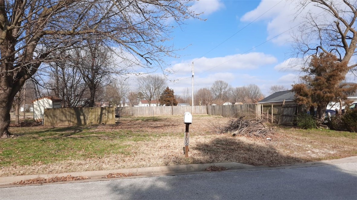 Level lot in an established neighborhood! Minutes away from I-49 and Highway 265. Very central location, don't want to miss out on this opportunity to build your own cozy home.