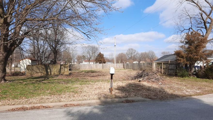 Level lot in an established neighborhood! Minutes away from I-49 and Highway 265. Very central location, don't want to miss out on this opportunity to build your own cozy home.