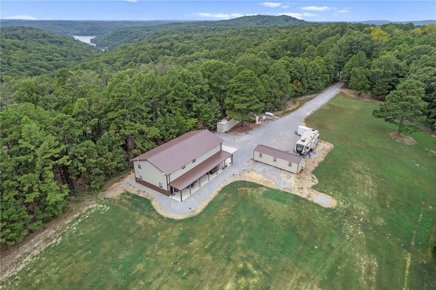 Gorgeous barndominium on a park-like setting minutes to the Clifty Boat Ramp in Eureka Springs, AR! Tucked off the road at 601 County Road 152, this well-kept retreat offers flexible purchase options of 8±, 22±, or 39± acres—bring your dreams, animals, and toys. The 2-bed, 2-bath layout features two living areas for easy entertaining or a home office/media space. An oversized garage provides exceptional storage/workshop potential for boats, UTVs, and equipment. Outdoors you’ll find manicured grounds that truly feel like a private park, plus a travel-trailer/RV hookup for guests or adventure-ready weekends. Enjoy quiet country living with quick access to Beaver Lake recreation fishing, boating, and swimming just about 5 minutes away—while still close to the dining, arts, and charm of historic Eureka Springs. A rare NWA find that blends low-maintenance living with room to grow, buy the home on 22± acres, add more land now, or secure the full 38± acres for your private estate or hobby farm.
