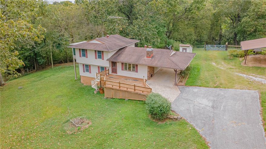 The opportunities are endless with this beautiful 46+ acre property. A paved driveway leads up to a 2BR/2BA farmhouse spread out over 3 levels. A large deck across the front of the house is the perfect spot for morning coffee. The Master BR on the upper level includes a sunroom addition w/ steps leading down to a spacious yard. The main level living room features natural light, a cozy brick fireplace & wood beams on the ceiling. A full bath, mud room & living area round out the lower level. The kitchen opens to the back porch/patio area. Steps away from the carport is a detached garage w/ lean-to for a total of 3 covered parking spots. Acreage is fenced & cross-fenced for livestock, or choose from one of the great building sites & enjoy the lovely views from your dream home. A barn, outbuilding and 2 chicken houses provide ample storage. The property has 2 functioning wells and 2 ponds. Enjoy country living close to the conveniences of town! House is sold as is. Property also listed as LAND 1161193 & FARM 1161192.