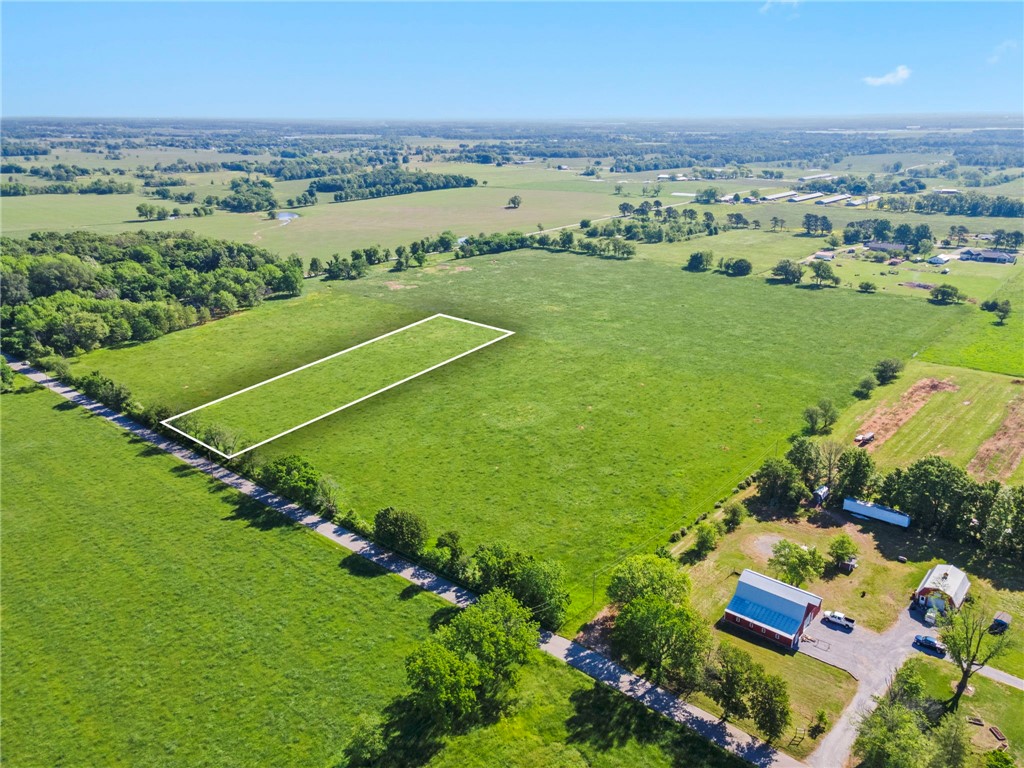 Just 10 minutes from the Northwest Arkansas airport, discover an exclusive opportunity to claim 2.03 acres of pristine, flat land where elegance and tranquility meet. This rare gem offers uninterrupted views of both sunrise and sunset, creating a breathtaking backdrop for a lifestyle of refined comfort and serenity. The land stretches wide and open beneath a vast sky, inviting you to dream without limits. Imagine a custom estate tucked into the peaceful landscape—grand entrances, sleek architecture, manicured grounds, and sophisticated outdoor spaces designed for hosting under the stars. Whether you’re envisioning a modern sanctuary or a timeless retreat, this land provides the foundation to build your legacy. Privacy, beauty, and convenience converge in one exceptional location—close to everything, yet far enough to feel like your own private escape. Your future deserves a setting this extraordinary. Let luxury begin here.