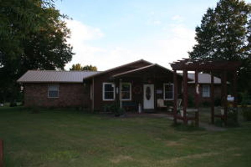 County home on 10+ acres with 4 BRs 1BA & detached 2 car garage. It has a open dining / kitchen area that offers an eat at bar. Laundry Room is located off kitchen, large pantry with room for a freezer, & a hall closet. There is even a enclosed back porch that has access from kitchen or master bedroom. The outside is an animal lovers paradise...Large Barn, storage building, & a chicken house ''condo'' complete with lights & automatic waters. The property is currently home to goats and the fencing is page wire & barb wire. Heat / air approx.  2 1/2 yrs old & roof if approx. 5-6 yrs old. Hot tub conveys, but is being conveyed as is & is not and has never been wired in. The heat system is a duel fuel unit and will use electric until the outside temp reaches 40 degrees and switches to propane.