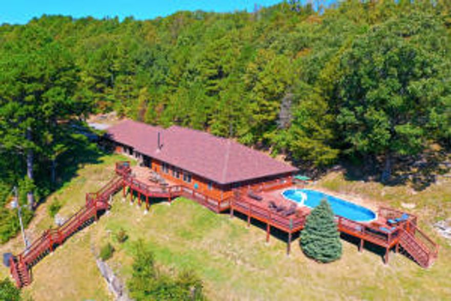 Check out this pristine country living estate located about 10 miles south of Downtown Eureka Springs Arkansas and less than 2 miles from the Kings river, This property includes two homes, a shop, paved driveway, backup power system and so much more.The main home was completely renovated in 2015 bringing the total living space to 3300+/- sq ft. and includes 6 bedrooms, 3 bathrooms, two living areas all in a single level  home.  As you enter the home you are immediately taken by the main living room that is warm and spacious with a large fireplace and beautiful windows looking out over the property. The interior layout is well thought out and would be a great place for a family or to entertain guests.