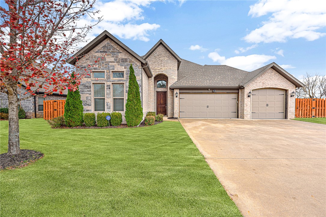 Welcome to your dream home in Liberty Bell North Rogers! This stunning 5-bedroom, 3.5-bathroom house offers 3,039 sqft of heated living space on a 0.26-acre lot. Built in 2017, the home features hardwood floors, an open-concept living area with a cozy gas log fireplace, and a gourmet kitchen with granite countertops, Energy Star appliances, and a walk-in pantry. The second level includes a versatile room that can be a bonus room or a 5th bedroom. The master suite boasts a walk-in closet, whirlpool tub, and separate shower. Outdoor living is perfect with a covered patio, screened porch, and outdoor fireplace, plus a beautifully landscaped, fenced yard with irrigation. Additional amenities include a 3-car attached garage with an epoxy floor, central vacuum system, security system, and energy-efficient LED lighting. Located near business districts, schools, and trails, this home combines city convenience with suburban tranquility. Enjoy the community pool and more! The refrigerator, washer, dryer, and patio TV convey.