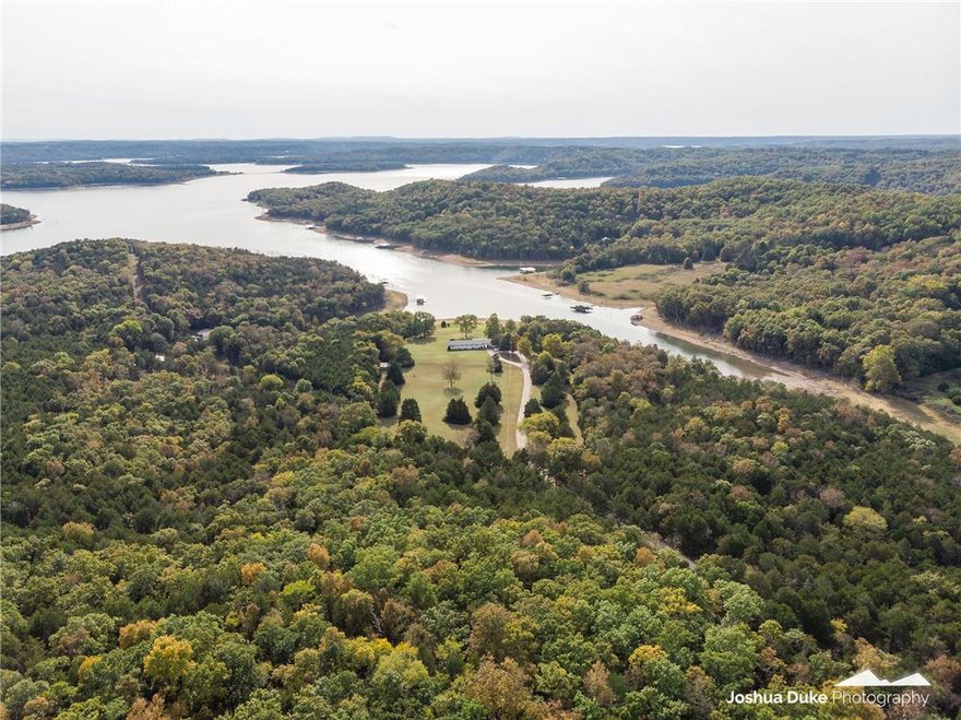 Wow! The ultimate setting! 18 acres, 4 beds, 3 baths with an almost level walk to your private dock. Peaceful, quiet country setting in Cedar Creek cove. No trees to block your view. Launch your boat next to the dock. New roof - 2014, Hvac - 2015, total interior painted - 2017, 2 water heaters, 3 potties - 2018. Plenty of land to build several homes or turn into a corporate retreat or just enjoy your privacy.  40 minute drive to Rogers or Eureka.  Don't miss out on this one.